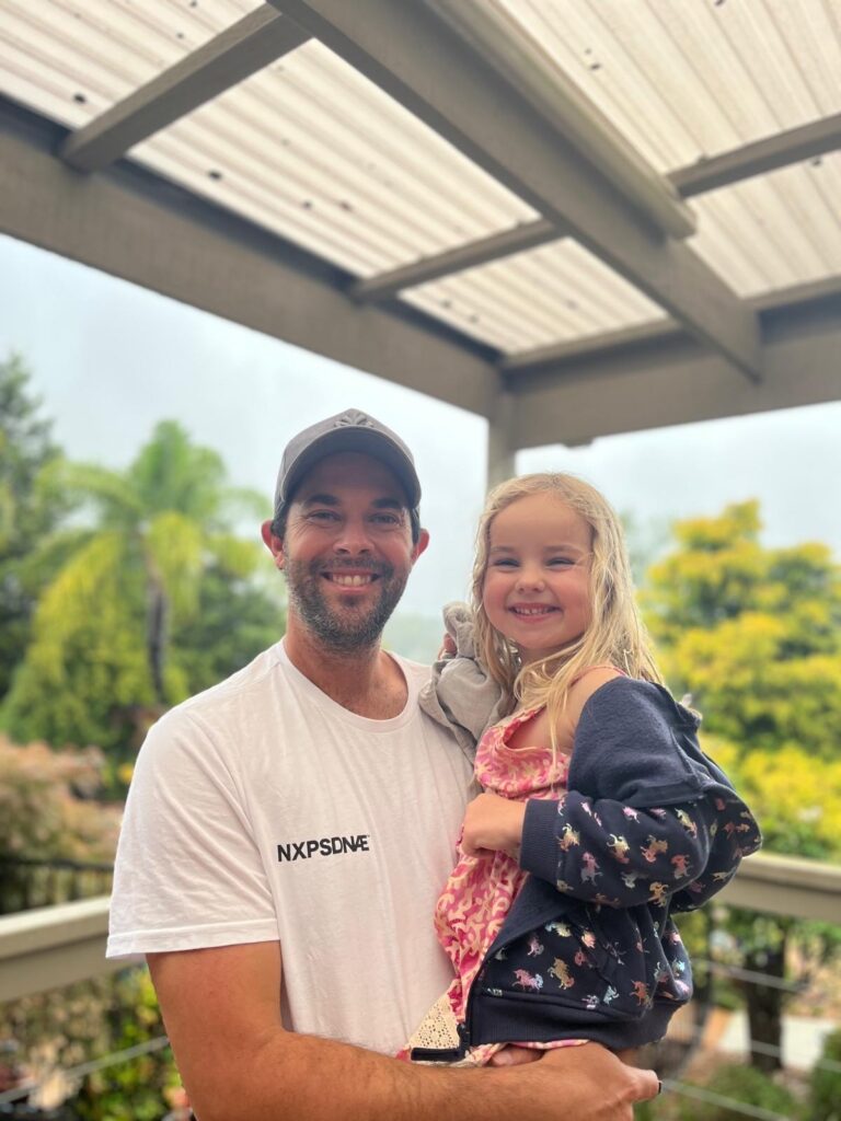 Image of a father and his daughter smiling