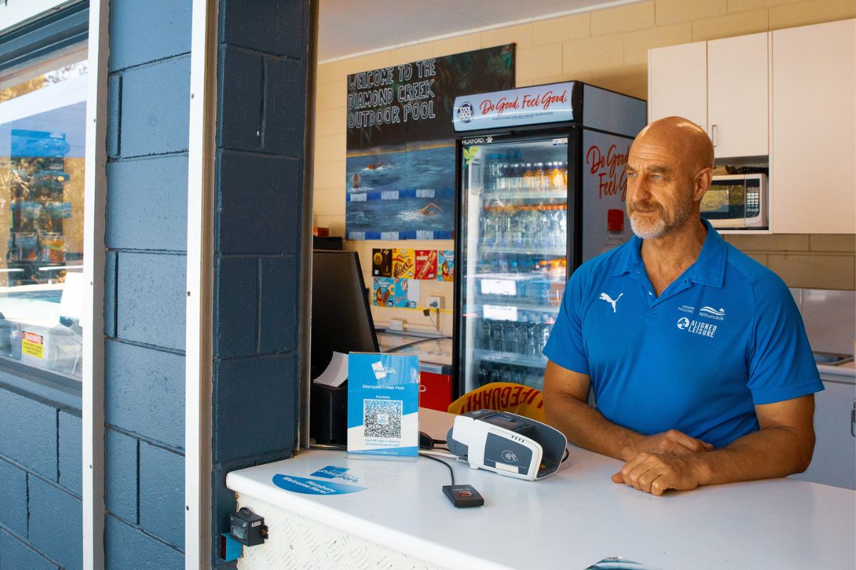 Diamond-Creek-Outdoor-Pool-Kiosk-Man-Overlooking-Pool.jpg